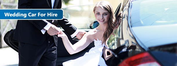 bride coming out of a wedding car